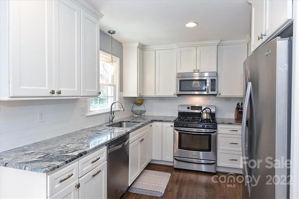 3616 Round Oak Road Charlotte, NC 28210 - Photo 15 of 48 a kitchen with granite countertop a sink stainless steel appliances and white cabinets
