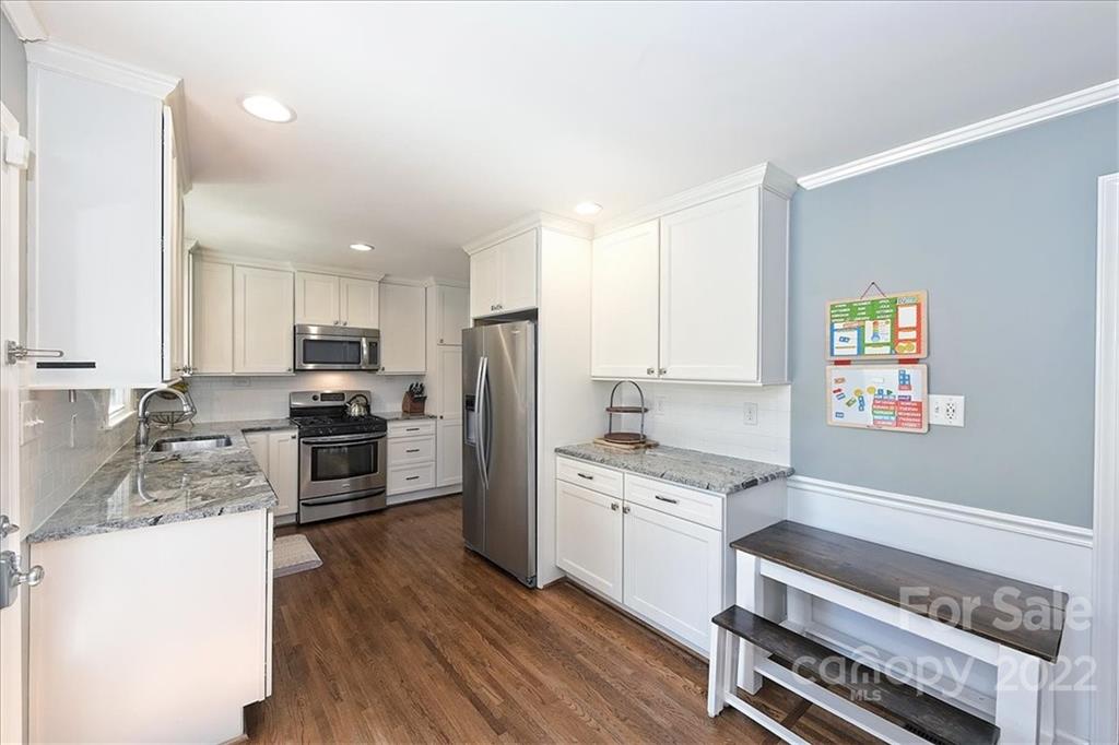 3616 Round Oak Road Charlotte, NC 28210 - Photo 16 of 48 a kitchen with granite countertop a refrigerator cabinets and wooden floor