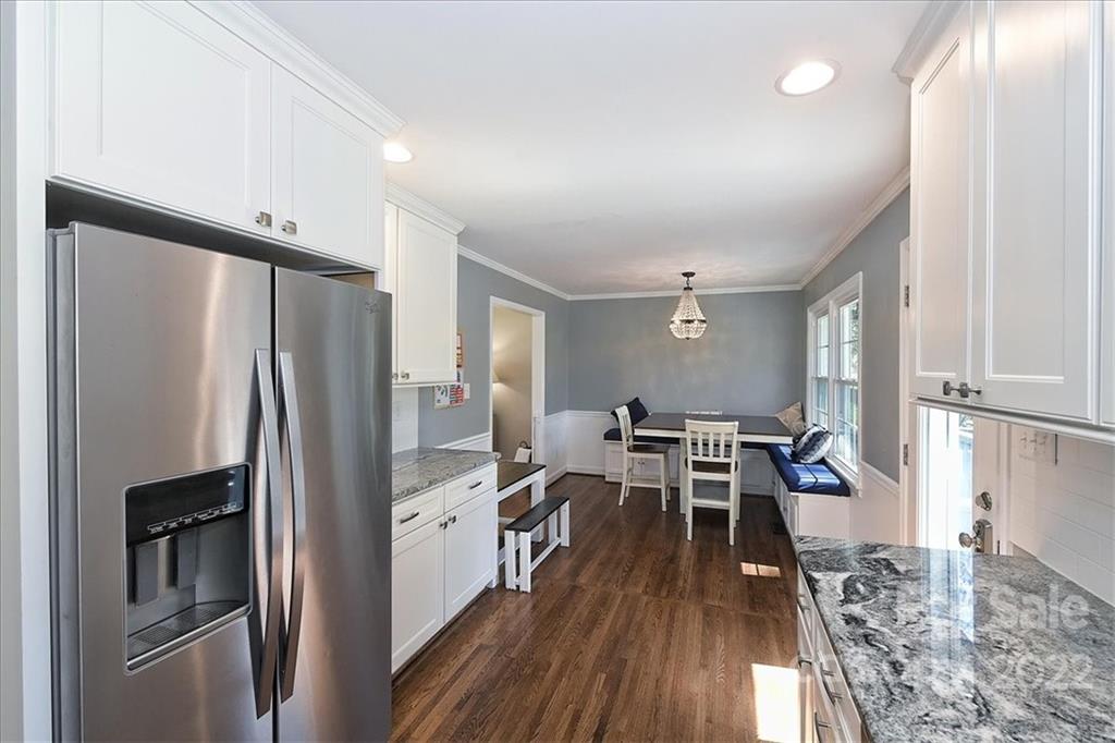 3616 Round Oak Road Charlotte, NC 28210 - Photo 18 of 48 a kitchen with stainless steel appliances a refrigerator a stove a sink and white cabinets with wooden floor