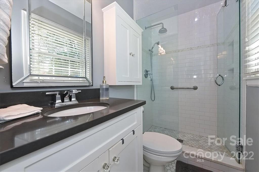 3616 Round Oak Road Charlotte, NC 28210 - Photo 25 of 48 a bathroom with a granite countertop sink toilet and shower
