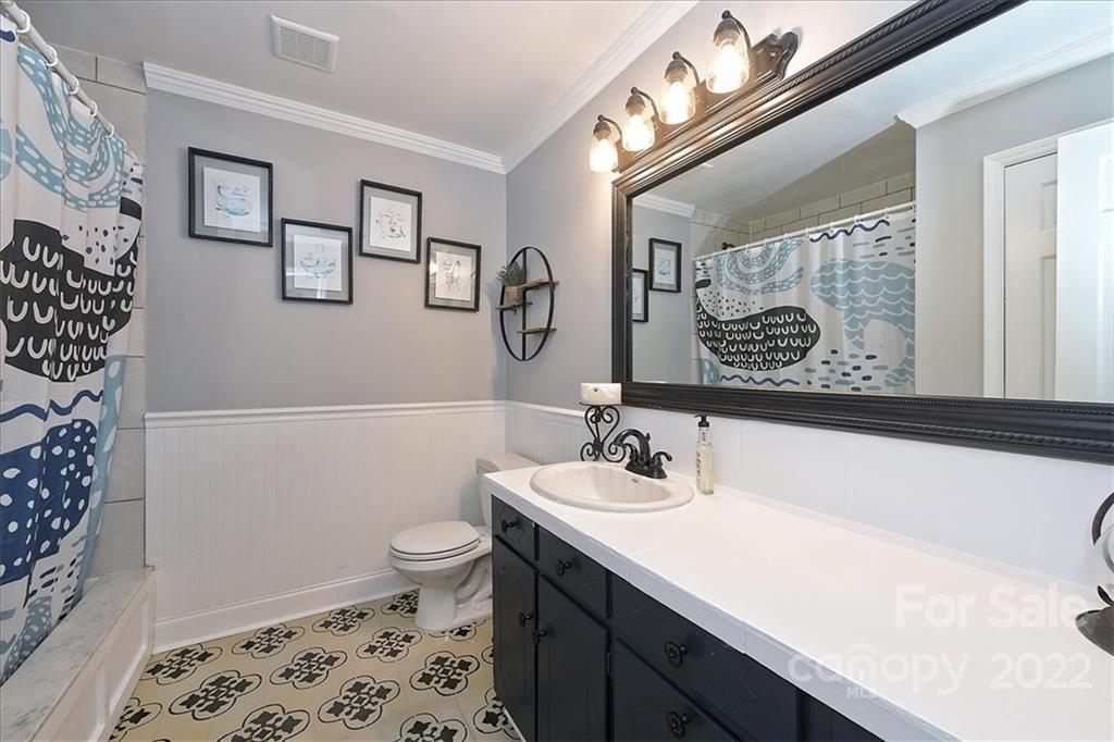 3616 Round Oak Road Charlotte, NC 28210 - Photo 28 of 48 a bathroom with a sink a toilet and shower