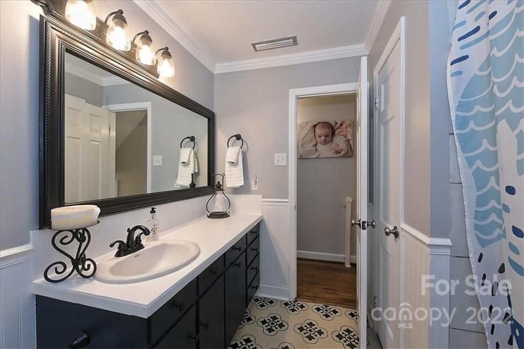 3616 Round Oak Road Charlotte, NC 28210 - Photo 29 of 48 a bathroom with a sink vanity and a mirror