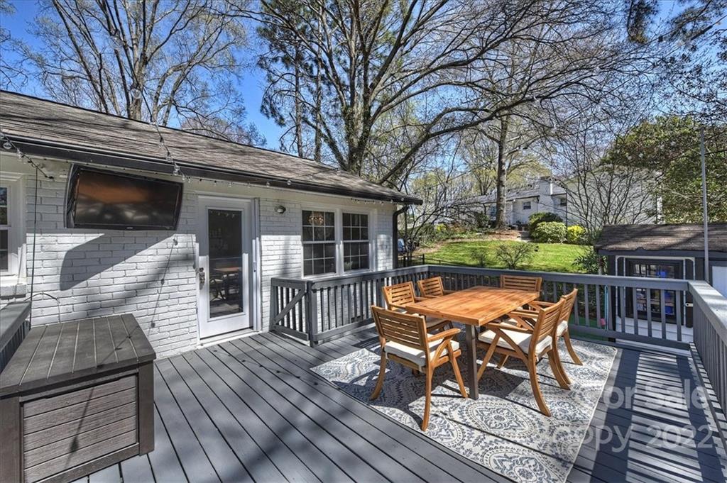 3616 Round Oak Road Charlotte, NC 28210 - Photo 38 of 48 a view of a roof deck with table and chairs and wooden floor