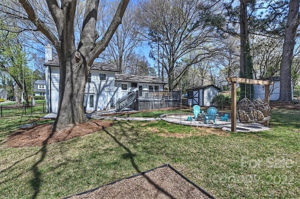 3616 Round Oak Road Charlotte, NC 28210 - Photo 47 of 48 a view of a backyard with fountain plants and large trees