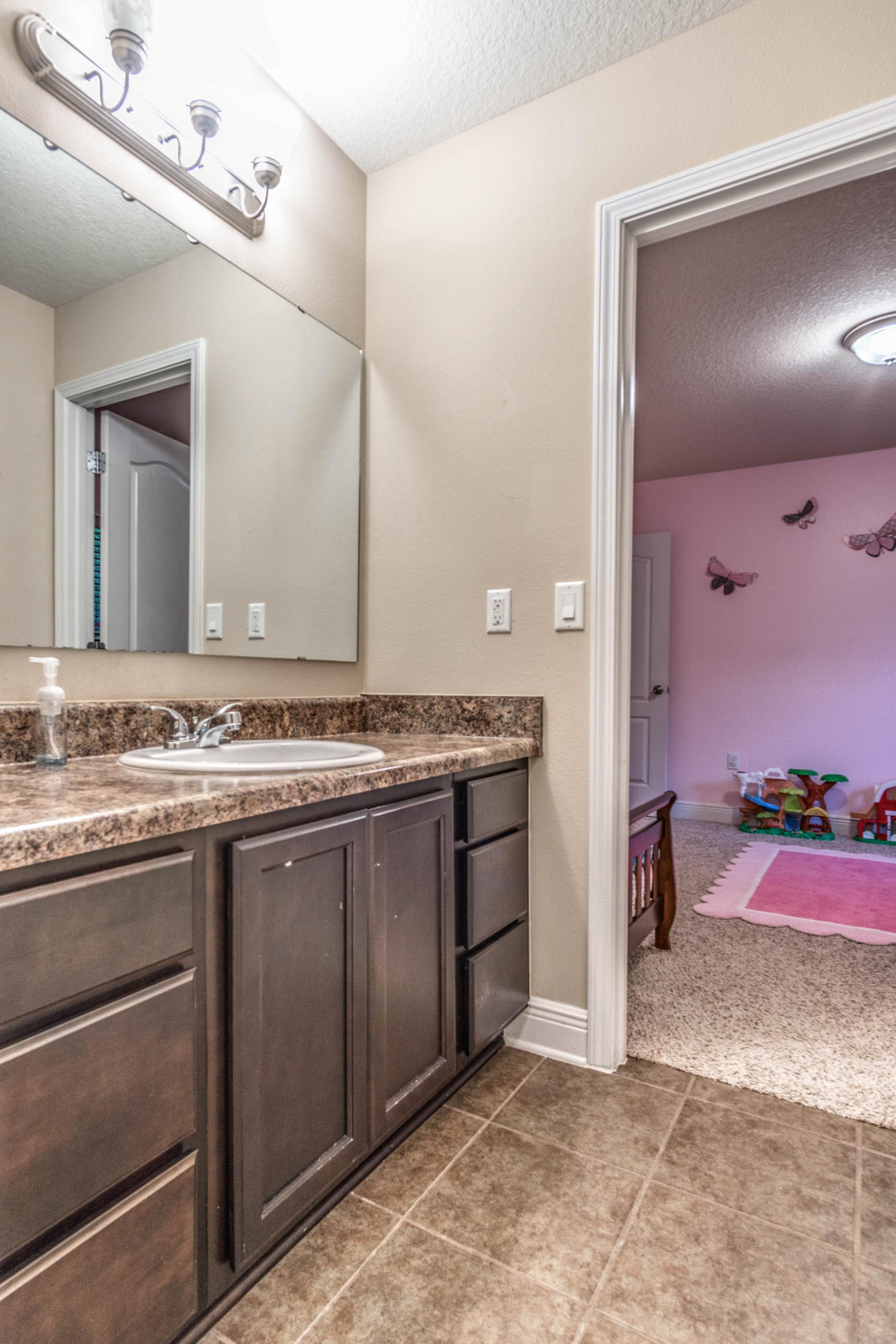 4504 Hermosa Road Crestview, FL 32539 - Photo 22 of 34 a spacious bathroom with a granite countertop sink and a mirror