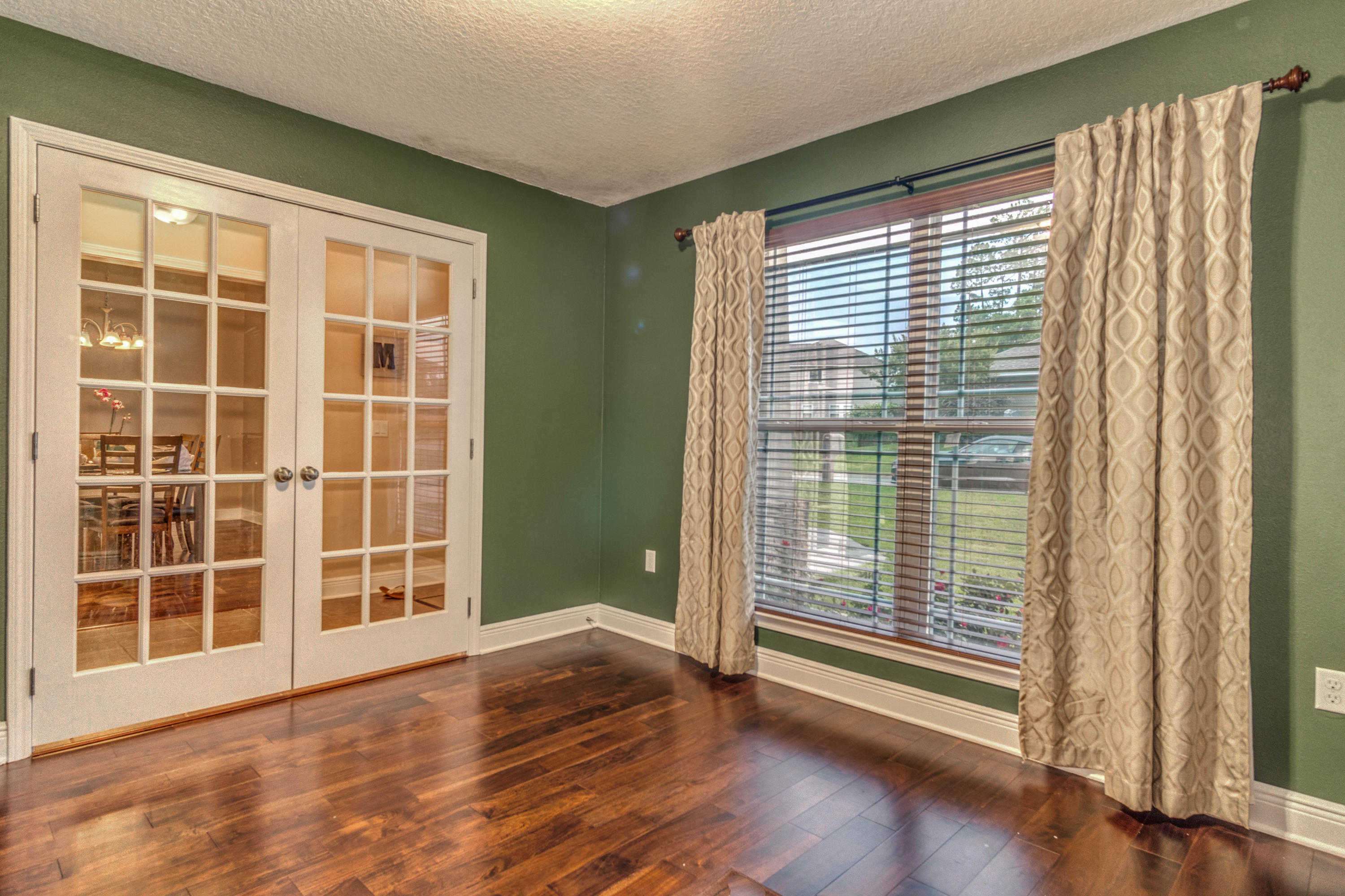 4504 Hermosa Road Crestview, FL 32539 - Photo 8 of 34 a view of empty room with wooden floor and fan
