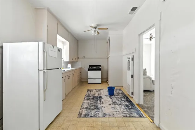 a kitchen with a refrigerator and a stove