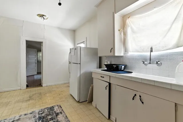 a kitchen with a refrigerator and a sink