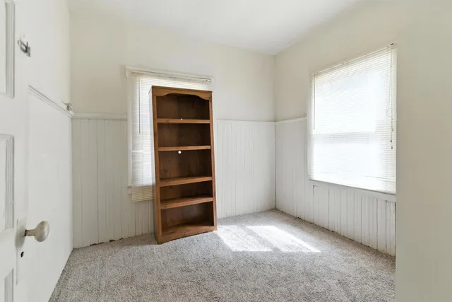 a view of an empty room with a closet
