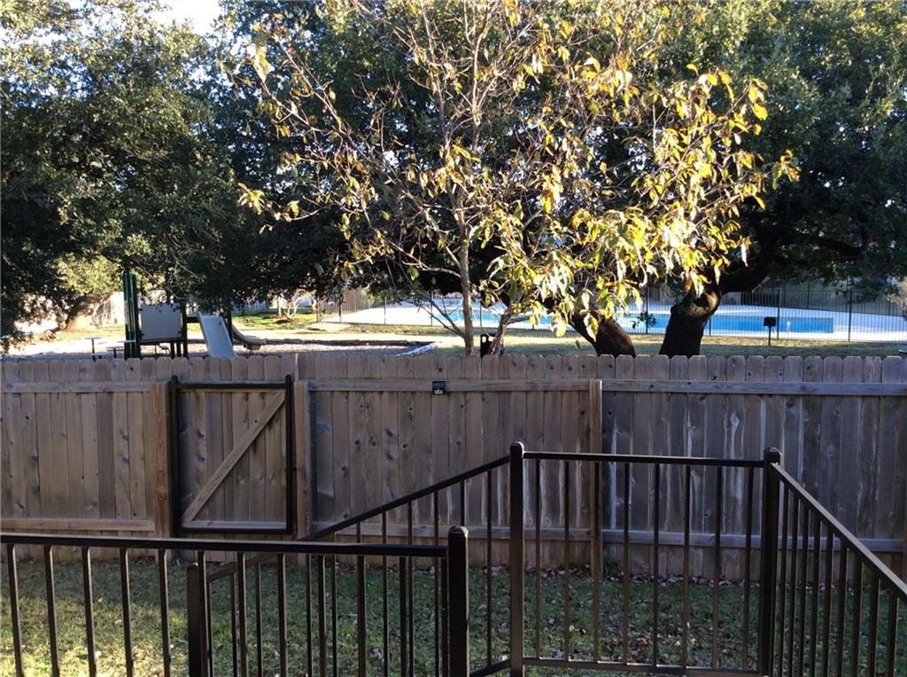 3451 Mayfield Ranch Boulevard, Unit 340 Round Rock, TX 78681 - Photo 9 of 13 House fence connects directly with the playground, picnic tables, and community center. Lots of mature trees!