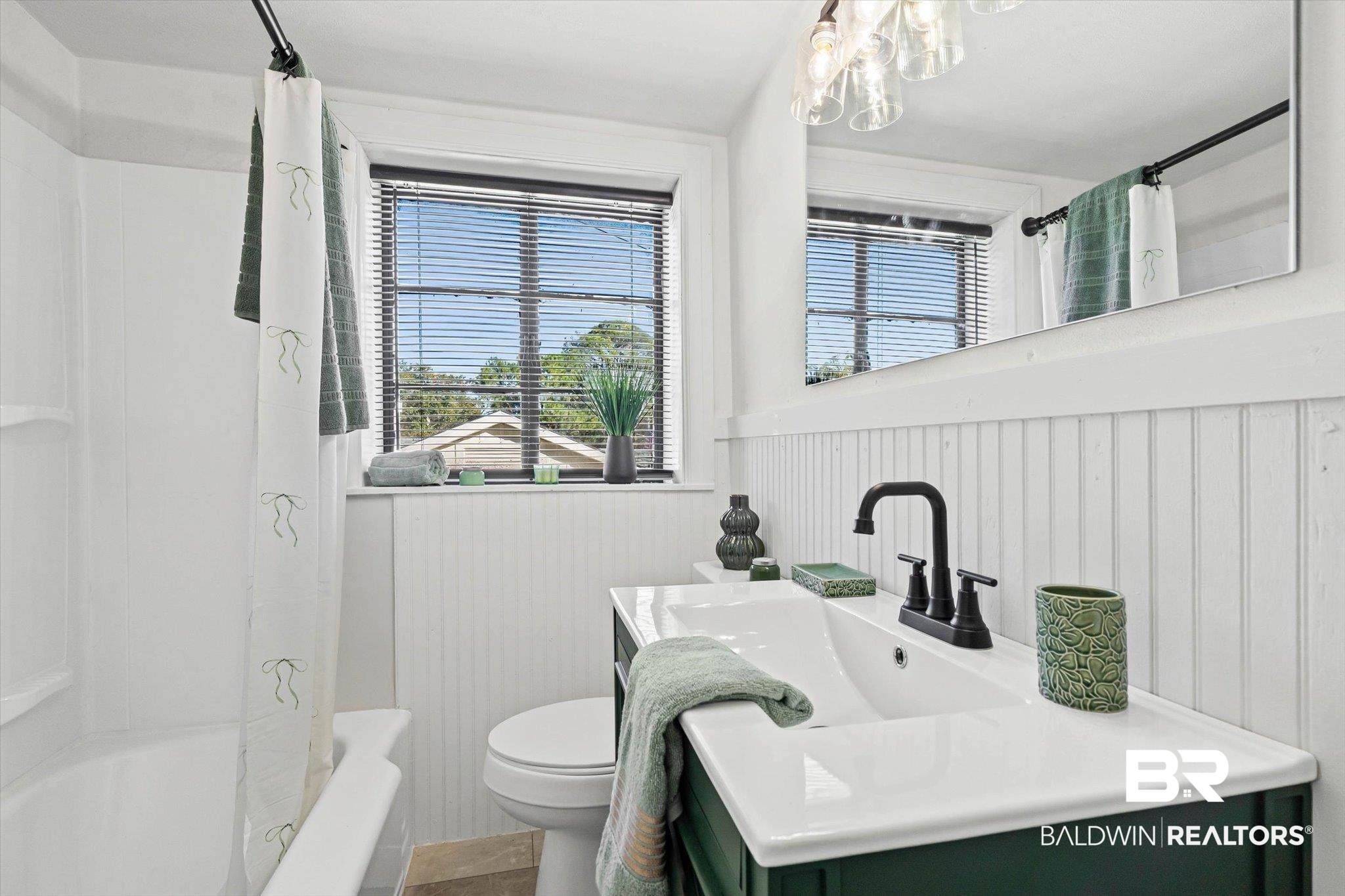 2806 Exter Drive Mobile, AL 36606 - Photo 16 of 24 Full bathroom featuring vanity, wainscoting, plenty of natural light, shower / bathtub combination with curtain, and a chandelier