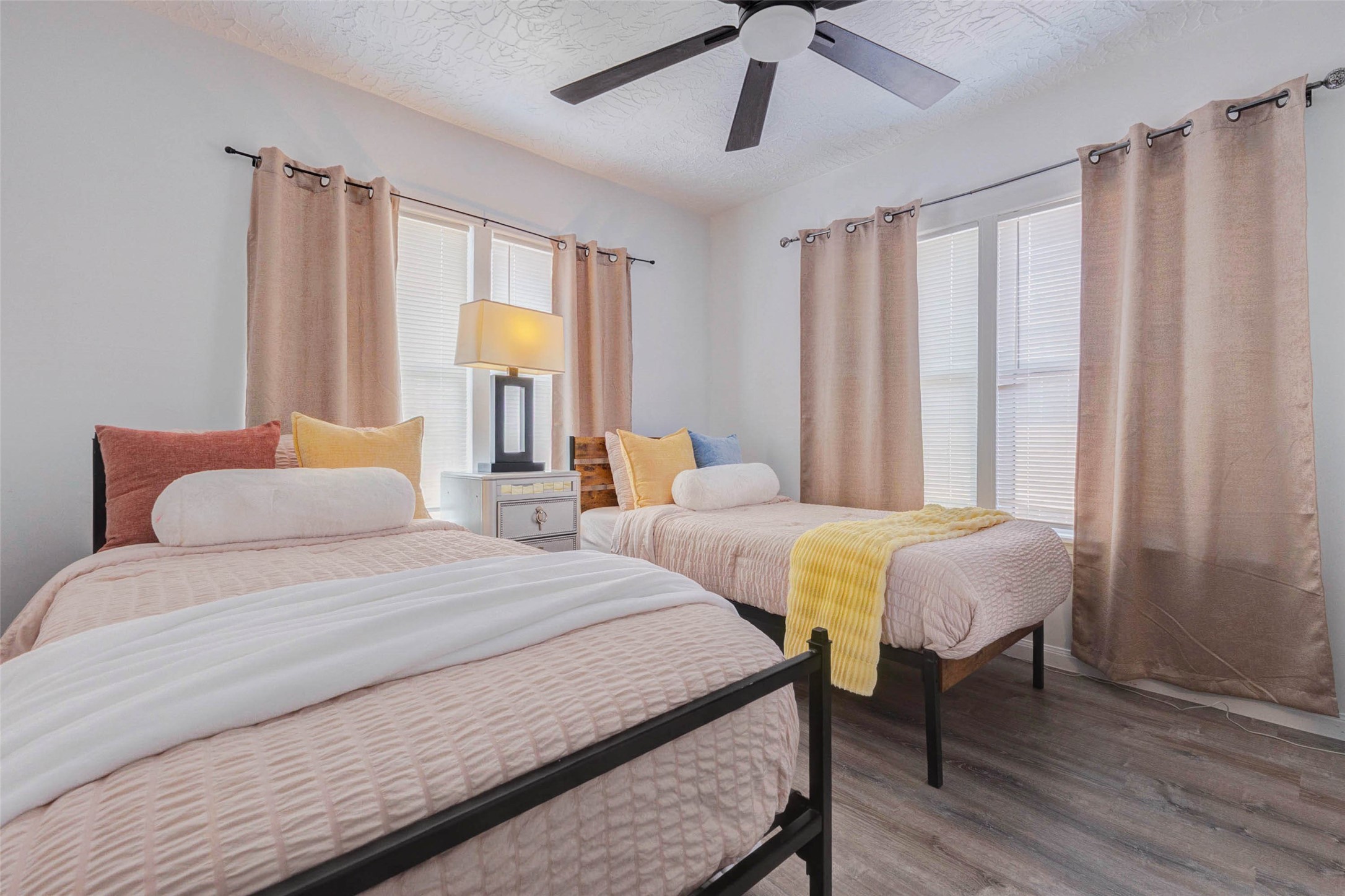 2902 Truxillo Street Houston, TX 77004 - Photo 20 of 32 a bedroom with two beds and a chandelier
