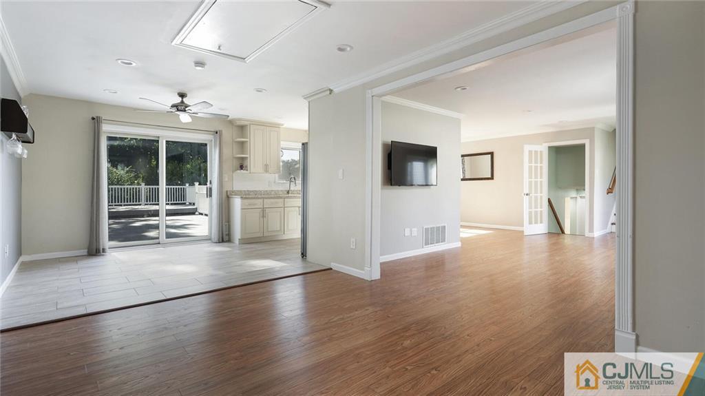 1884 Holly Road North Brunswick, NJ 08902 - Photo 11 of 39 an empty room with wooden floor and windows