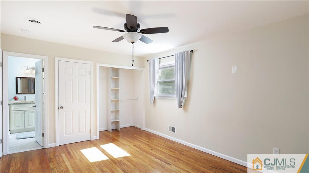 1884 Holly Road North Brunswick, NJ 08902 - Photo 21 of 39 a view of a livingroom with a chandelier fan and wooden floor