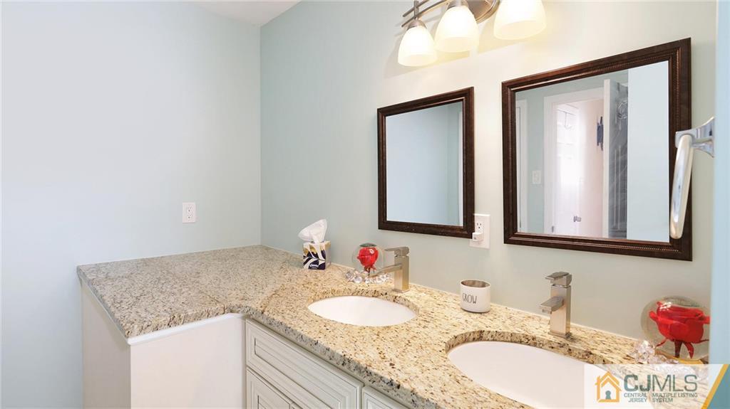 1884 Holly Road North Brunswick, NJ 08902 - Photo 23 of 39 a bathroom with a granite countertop sink and a mirror