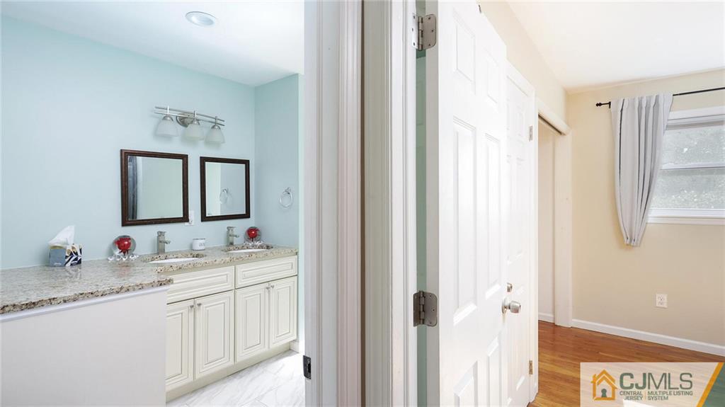 1884 Holly Road North Brunswick, NJ 08902 - Photo 24 of 39 a bathroom with a sink and a mirror