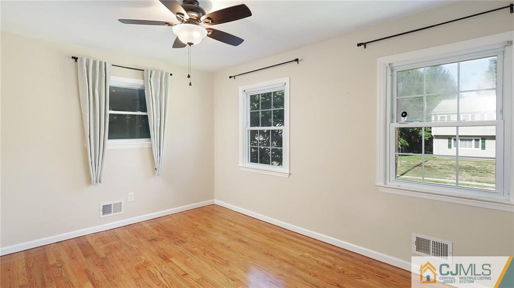 1884 Holly Road North Brunswick, NJ 08902 - Photo 25 of 39 a view of an empty room with a window and wooden floor