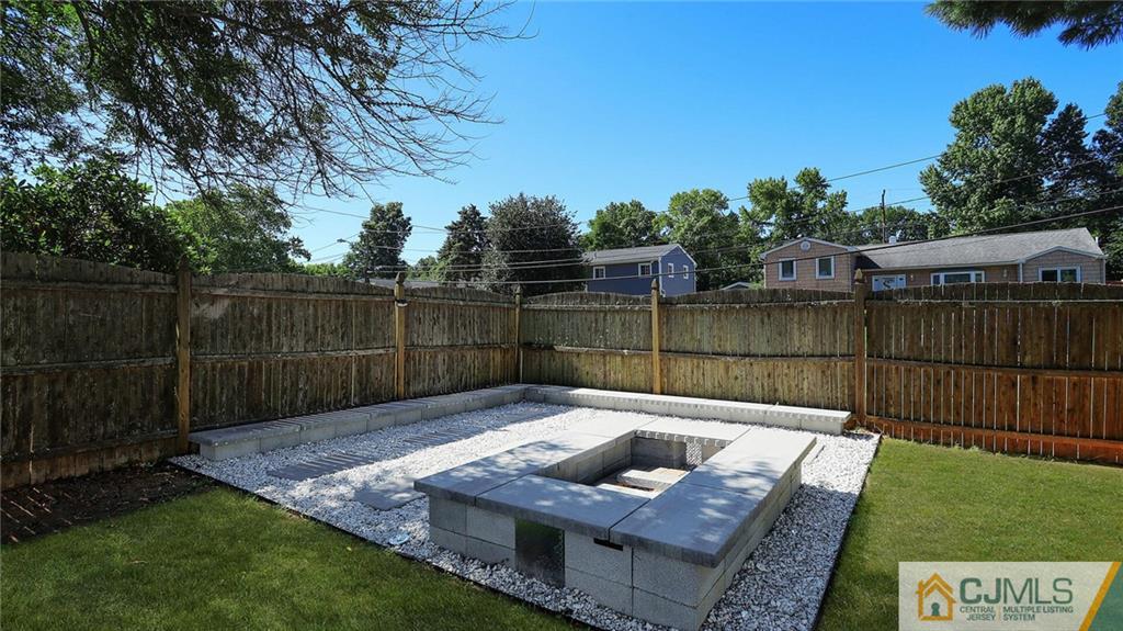 1884 Holly Road North Brunswick, NJ 08902 - Photo 32 of 39 a view of a backyard with couches plants and wooden fence