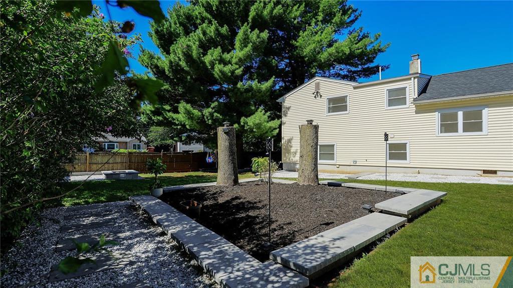 1884 Holly Road North Brunswick, NJ 08902 - Photo 38 of 39 a view of a backyard with couches plants and large tree