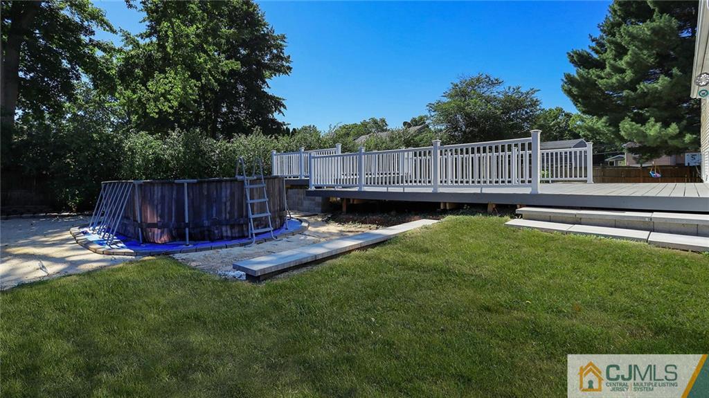 1884 Holly Road North Brunswick, NJ 08902 - Photo 39 of 39 a view of a backyard with a small cabin and wooden fence