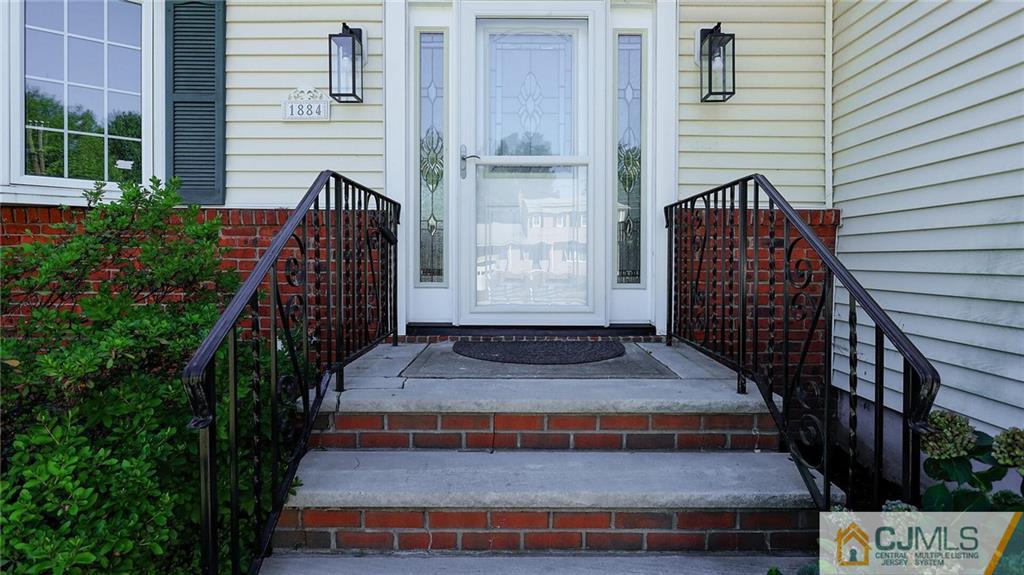 1884 Holly Road North Brunswick, NJ 08902 - Photo 4 of 39 a front view of a house with a yard
