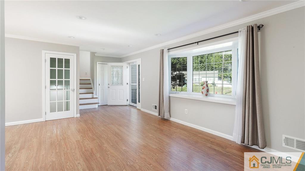 1884 Holly Road North Brunswick, NJ 08902 - Photo 7 of 39 an empty room with wooden floor and windows