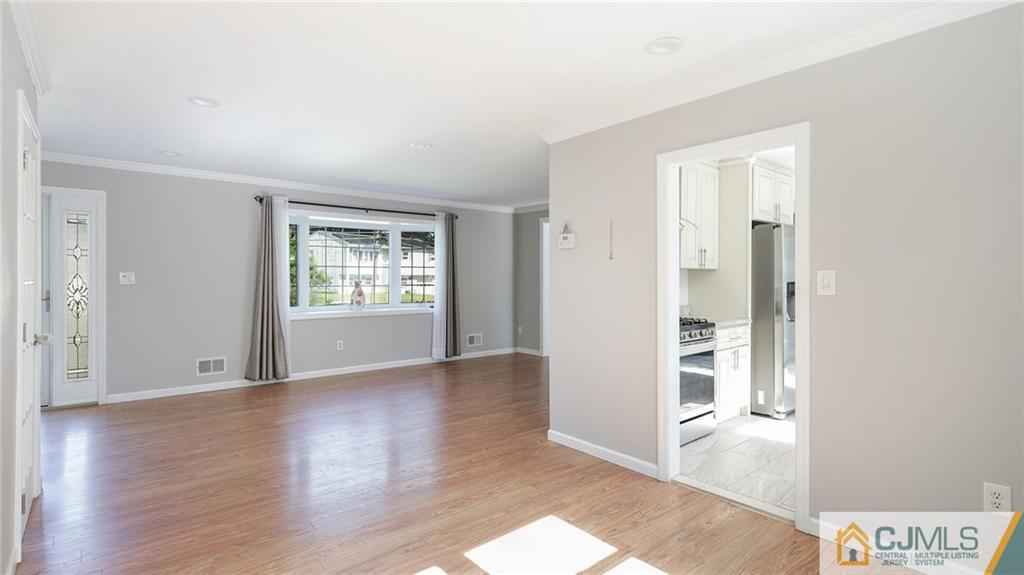 1884 Holly Road North Brunswick, NJ 08902 - Photo 9 of 39 wooden floor in an empty room with a window