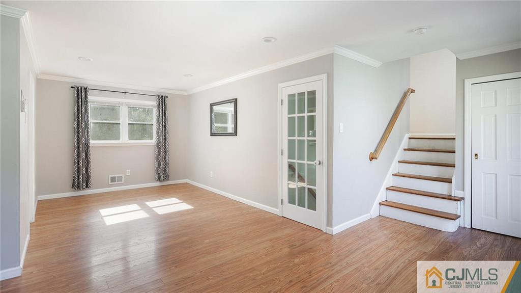 1884 Holly Road North Brunswick, NJ 08902 - Photo 10 of 39 a view of an empty room with wooden floor and a window