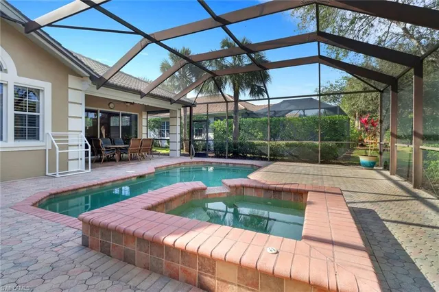 a view of a patio with a table chairs and a potted plant