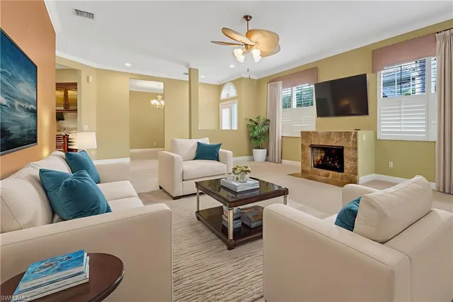 a view of a dining room with furniture and chandelier