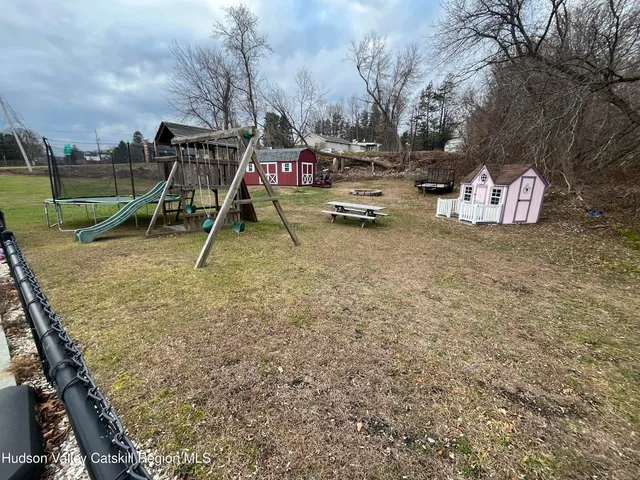 a view of outdoor space with playground and green space
