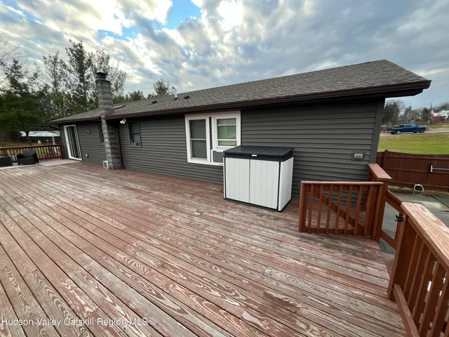 a backyard of a house with table and chairs