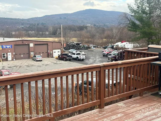 a balcony view with two chairs and a table