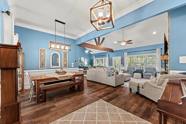 a living room with furniture a fireplace and a large window