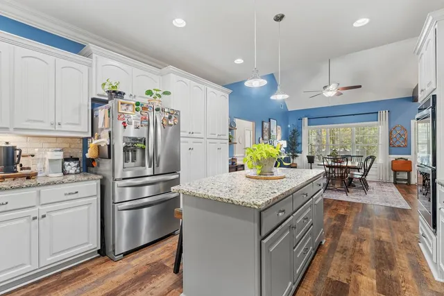 a kitchen with white cabinets and stainless steel appliances