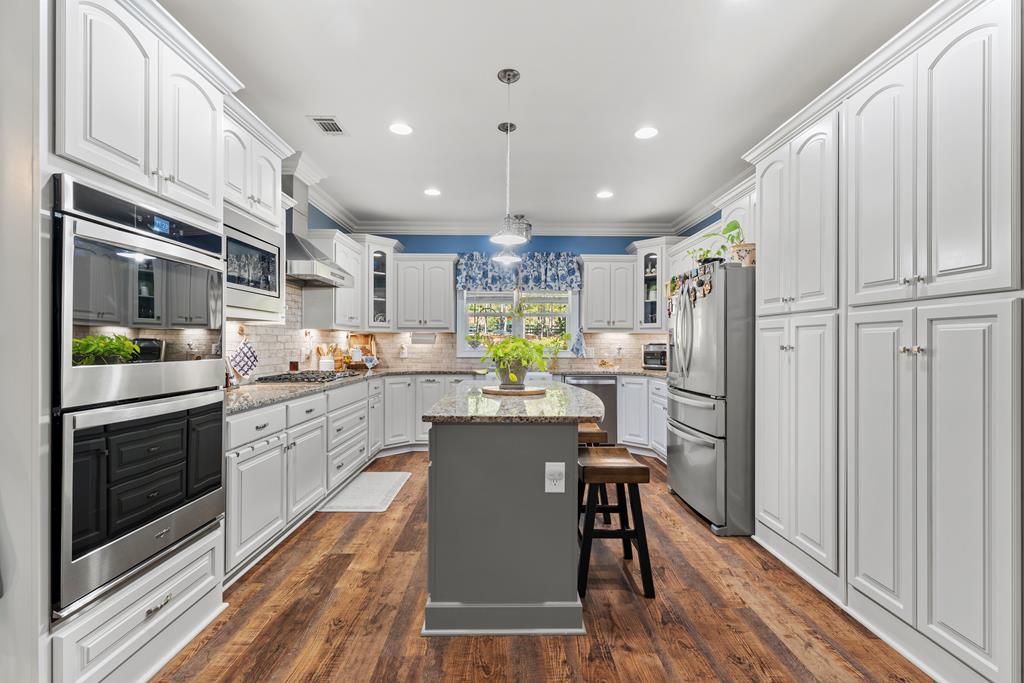2800 Hopewell Church Road Pine Mountain, GA 31822 - Photo 19 of 38 a kitchen with refrigerator cabinets and wooden floor