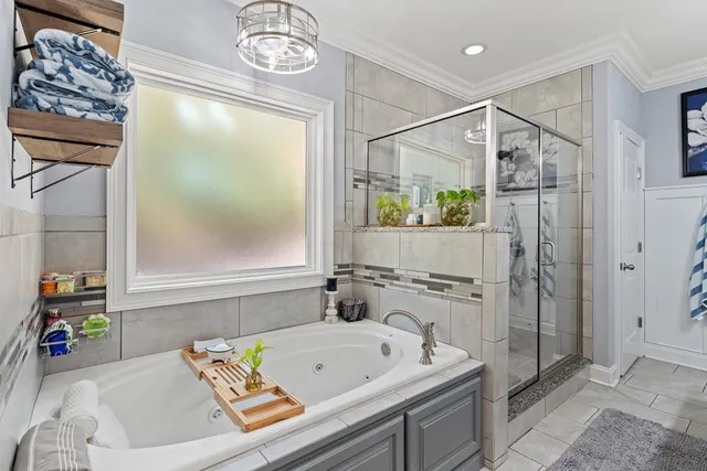 a bathroom with a tub a sink and a shower