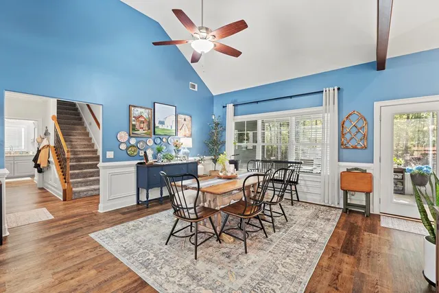 a dining room with furniture a rug and wooden floor