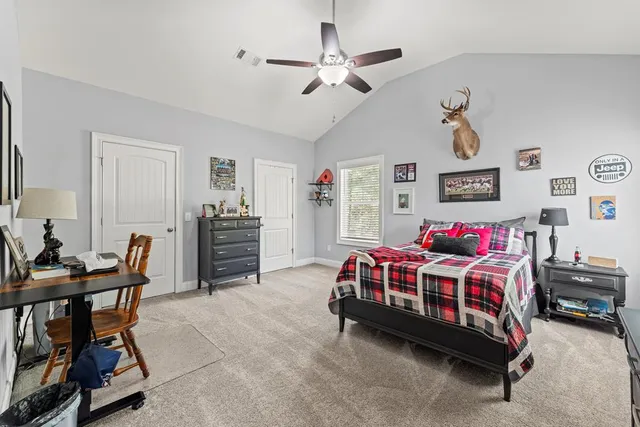 a bedroom with a bed and a chair in it