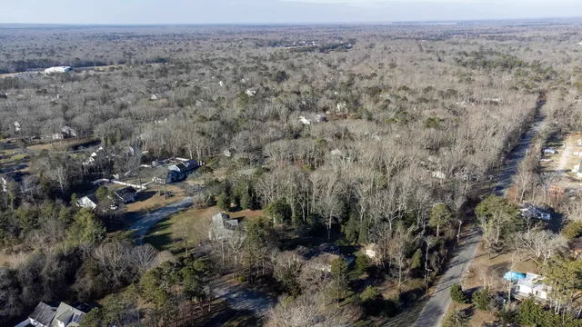 an aerial view of house with yard and mountain view in back