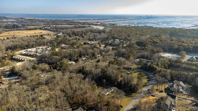a view of a house with a tree and a yard