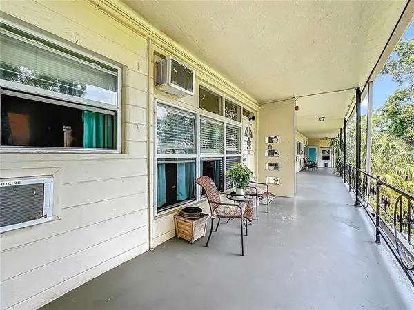 a view of a patio with table and chairs and a barbeque
