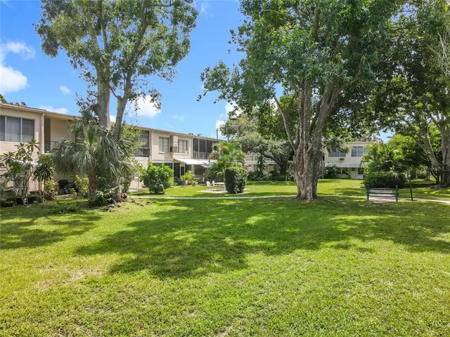 a view of a house with a tree in a yard