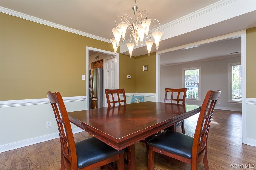 5702 Grove Forest Road Midlothian, VA 23112 - Photo 8 of 30 a view of a dining room with furniture and wooden floor