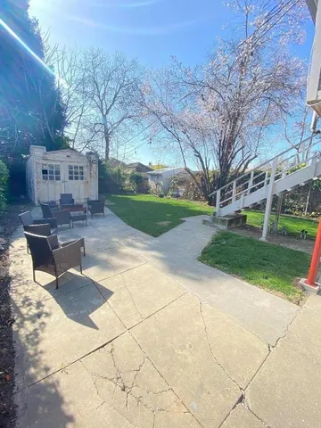 a view of backyard with outdoor seating