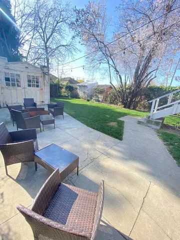 a view of a backyard with sitting area