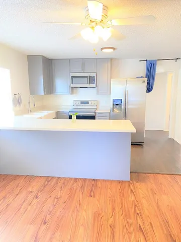 a view of kitchen with wooden floor