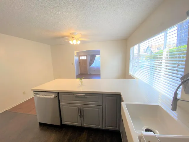 a room with a sink cabinets and a window