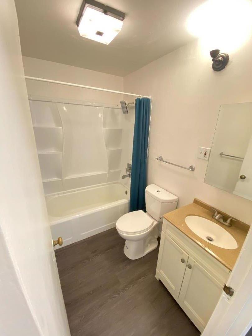 1818 63rd Street Berkeley, CA 94703 - Photo 9 of 15 a white toilet sitting next to a bath tub