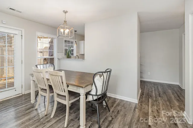 a view of a dining room with furniture wooden floor and chandelier